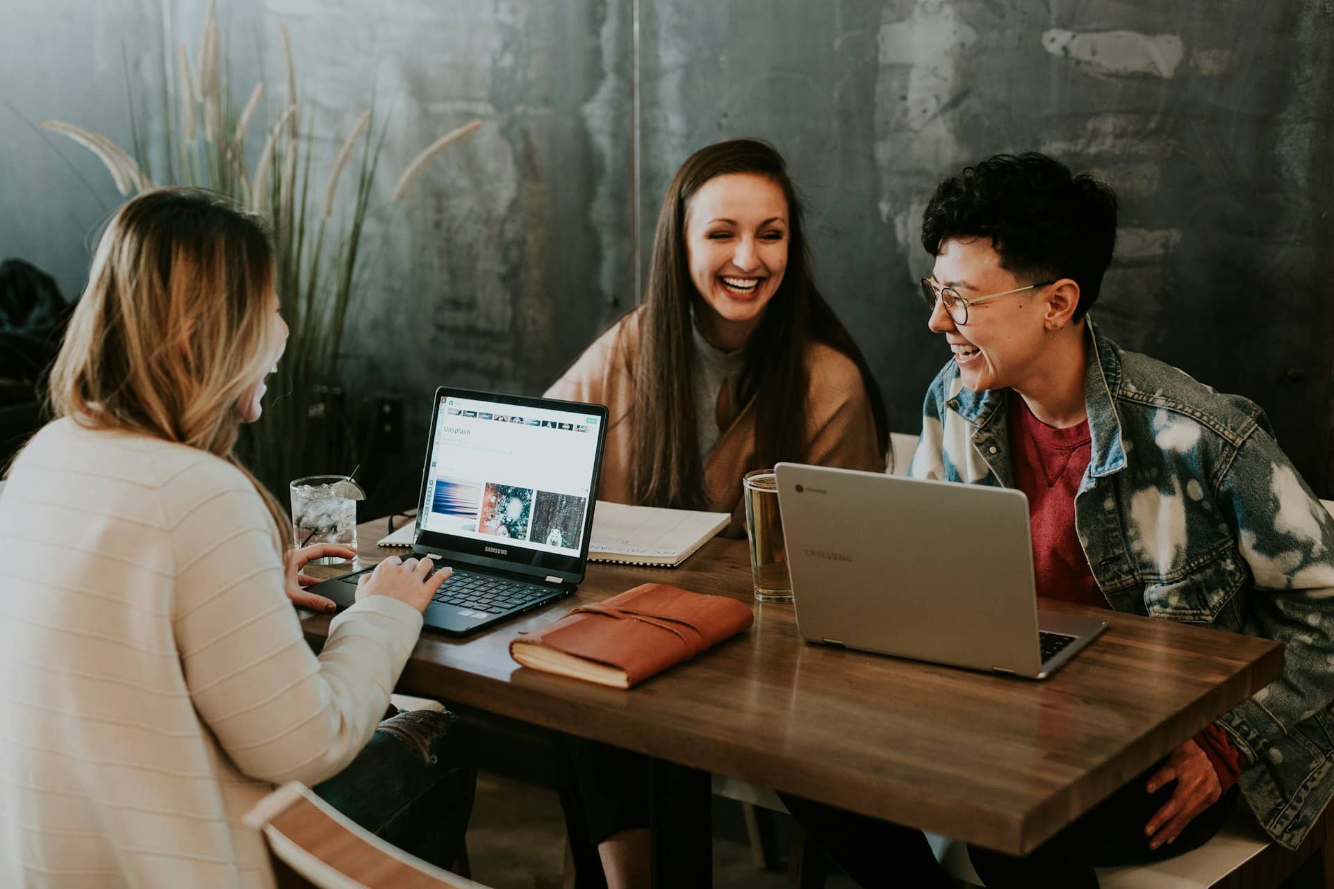 People collaborating over a laptop in a modern workspace